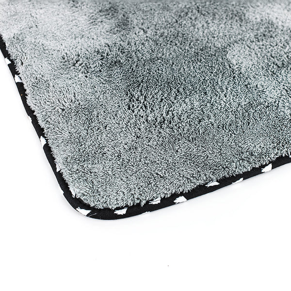 The corner of the light grey wolfpack towel on a white background.