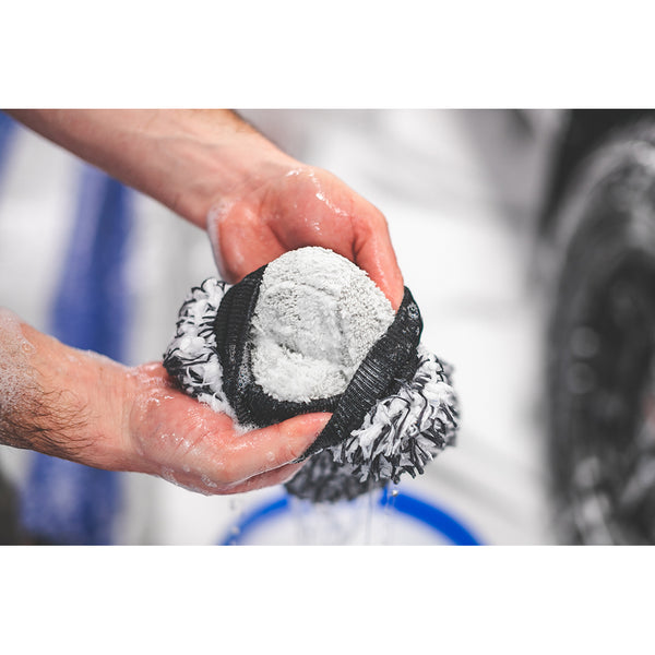 A closeup of someone showcasing the inside of The Rag Company Ultra Wash Mitt.