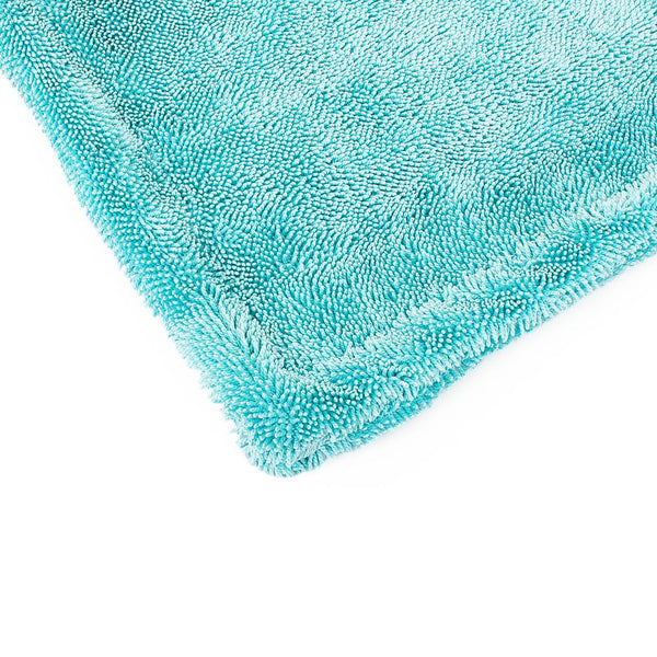 The corner of a Twist Loop towel on a white background.