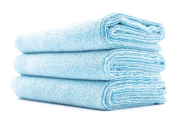 A stack of light blue sport workout towels.