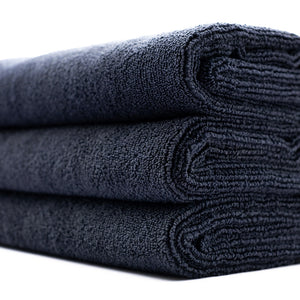 A stack of midnight black sport workout towels.