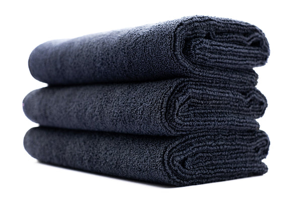 A stack of midnight black sport workout towels.