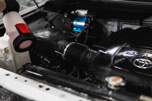 Armour Detail Clean being used on a car engine with a focus on mechanical components.