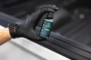 Armour Detail Supply Trim Plus 50ml bottle being held in a persons hand/