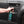 A closeup of a person spraying the side of their car with Armour Adapt.