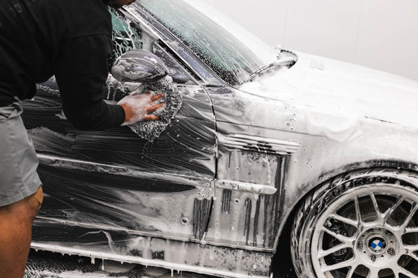 A person cleaning a car with a Cyclone pad.