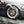 A closeup of a person power washing a car tire.