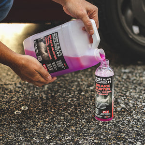 A person pouring P and S Brake buster from a jug into a spray bottle.