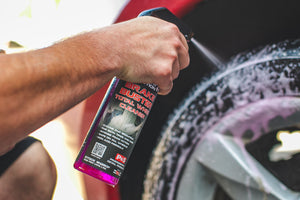 A person spraying P and S Brake Buster onto the rim of a tire.