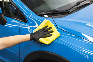 Citrus Twist towel wiping off a blue car.