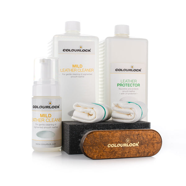 A product bundle featuring COLOURLOCK leather care items, including bottles of Mild Leather Cleaner and Leather Protector, a wooden brush with the COLOURLOCK logo, two white cleaning cloths, and a black sponge. The items are neatly arranged and designed for cleaning and protecting pigmented smooth leather surfaces.