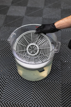Detail Factory Clean Screen being inserted into a soapy bucket.
