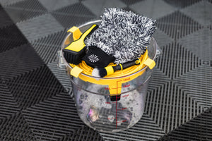 Detail Factory Clean Screen Livewire placed on top of a clear wash bucket, holding detailing brushes and a microfiber wash mitt.