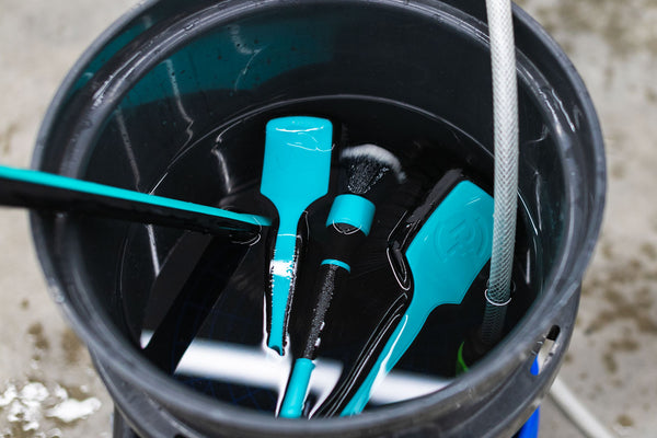 Detail Factory TriGrip Riptide products inside of a bucket filled with water.