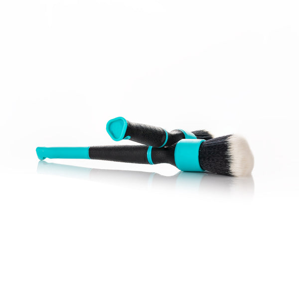 Two Riptide Trigrip Brushes crossing each other on a white background.