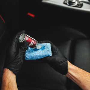 A person pouring Diamond Protech Diamond Leather onto a blue sponge.