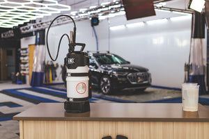iK e Foam Pro 12 on a table with a car in the background.