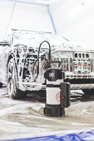An iK e Foam Pro 12 in front of a soapy vehicle.