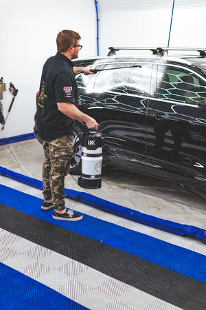 Person washing an Audi car with an iK e Foam Pro 12.