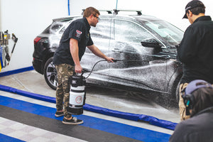 Person washing an Audi car with an iK e Foam Pro 12.