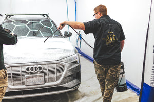Person washing an Audi car with an iK e Foam Pro 12.
