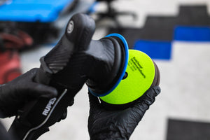 A person attaching a KochChemie Polish and Sealing Pad onto a Rupes polisher.