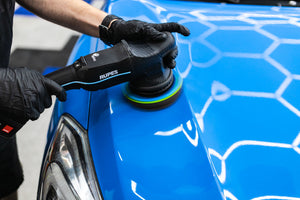 Rupes polisher using a KochChemie Polish and Sealing pad on a blue vehicle.