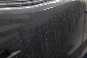 Grey Toyota Tacoma with Koch Chemie Protector Wax applied, showcasing water droplets not sticking to the surface of the vehicle.