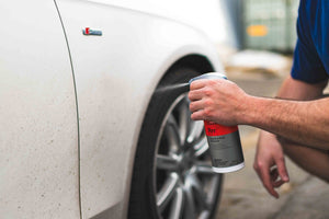 Person spraying KochChemie Reactive Rust Remover on a car