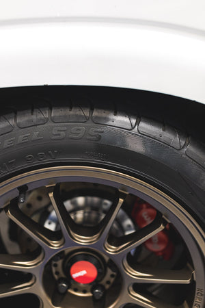 Close-up of a car tire with a gold rim.