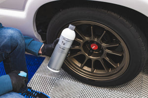 Person cleaning a car's tire with KochChemie Tire Glaze.