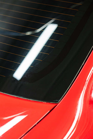 Opti-Coat MDR after on a rear window of a red car.