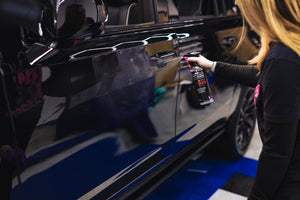 Person spraying P&S Inspiration Defender onto the side of a car.