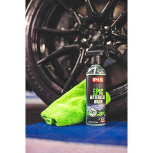 A green towel and bottle of P and S Epic Waterless Wash in front of a car tire.