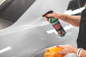 P&S Paint Prep being sprayed onto the side of a car.