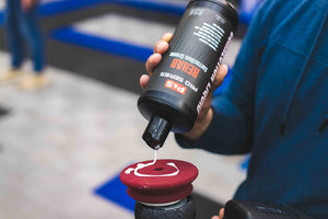 P&S Rehab being poured onto a maroon polishing pad connected to a rupes polisher. 