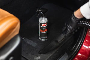 A bottle of P&S Release on the floor of the car.