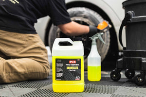 Person cleaning a tire with P&S Undressed and a Detail Factory Wheel Brush.