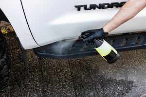 Person cleaning a white Toyota Tundra truck with an iK Sprayer filled with P&S Undressed.
