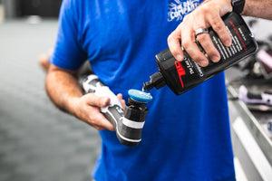 A person using a rupes da coarse pad on a polisher with TLD Compounding Glaze.