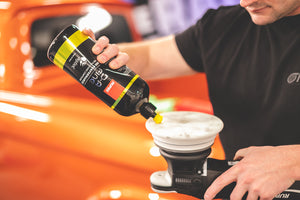 Rupes Da fine being poured onto a polishing pad attached to a polisher.