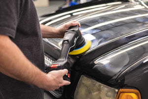 A person using a rupes da yellow pad on a rupes polisher.