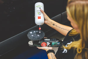 A person pouring Rupes Uno Advanced onto a polisher.