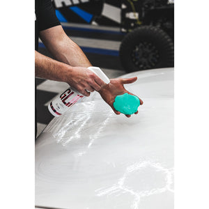 A person spraying Stjarnagloss Clay Lubricant on a green blob.