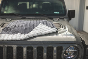 Using the 30 inch by 36 inch Gauntlet towel from The Rag Company to dry the hood of a Jeep GladiatorThese towels are Ice Grey on One side and Gauntlet Grey on the other with a scratchless suede edge banding them together