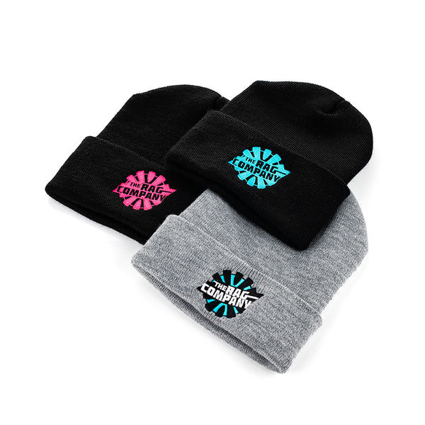 An image with three beanies with embroidered logos for The Rag Company. One is a black beanie with a pink logo. One is a grey beanie with a full color Black, white, and blue logo. One is a black beanie with a blue logo