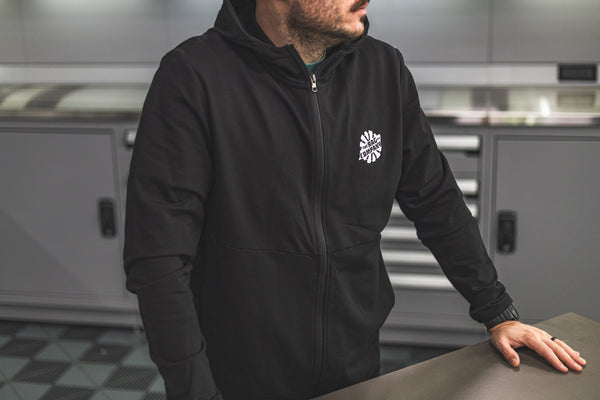 The Rag Company Performance Zip Hoodie black front view of man wearing the hoodie. 