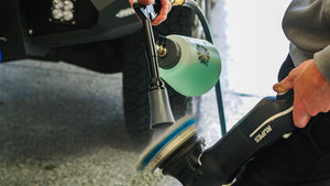 A person spraying a polisher with The Rag Company Ultra Air Blaster Plus.