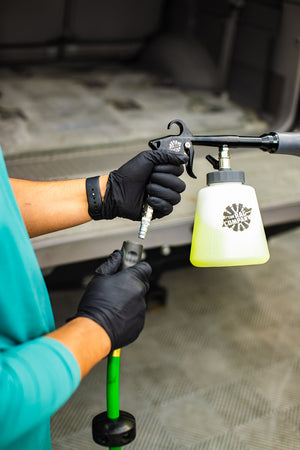 A person connecting a hose to The Rag Company Air Blaster Plus.