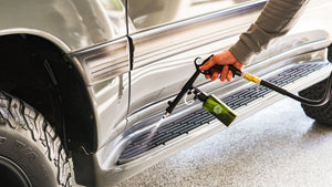 A person spraying the foot step of a truck with The Rag Company Ultra Air Spray Applicator.